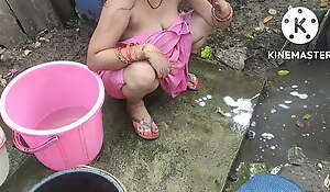 Indian abode wife bathing outside