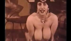 Retro stripper with reference to long gloves and stockings erotically dance exposing obese breasts