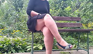 Lustful MILF pissing while sitting on a bench